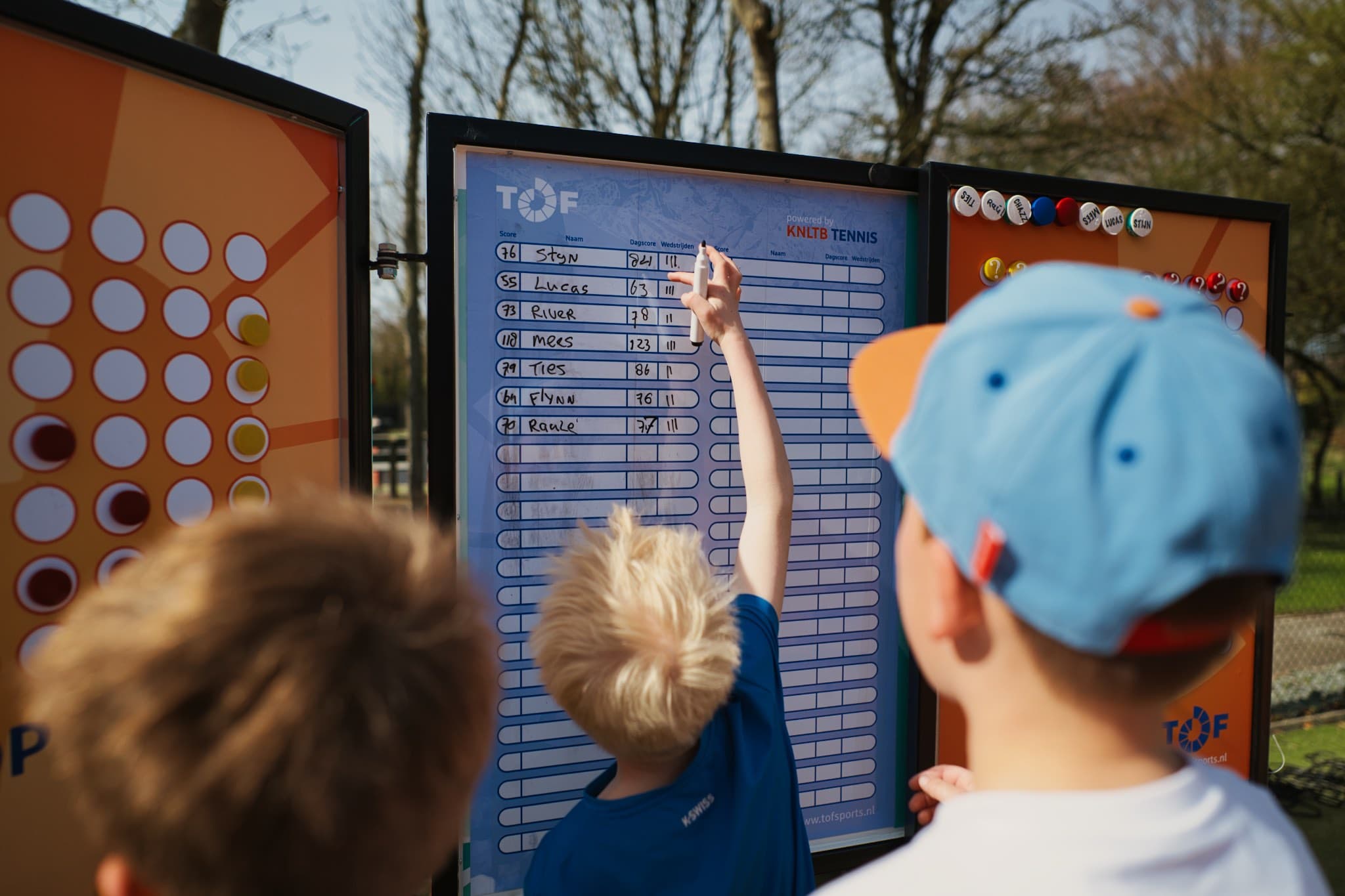 Kinderen bij het Tofscore-scorebord op de club